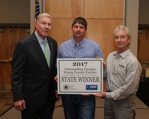 Brandon Branch of Baxley, Ga., receives Outstanding Georgia Young Peanut Farmer Award for 2017 during the 41st annual Georgia Peanut Farm Show held Jan. 19, 2017 in Tifton, Ga. Pictured left to right: Armond Morris, chairman of the Georgia Peanut Commission, Branch and David Hinson, business representative with BASF. 